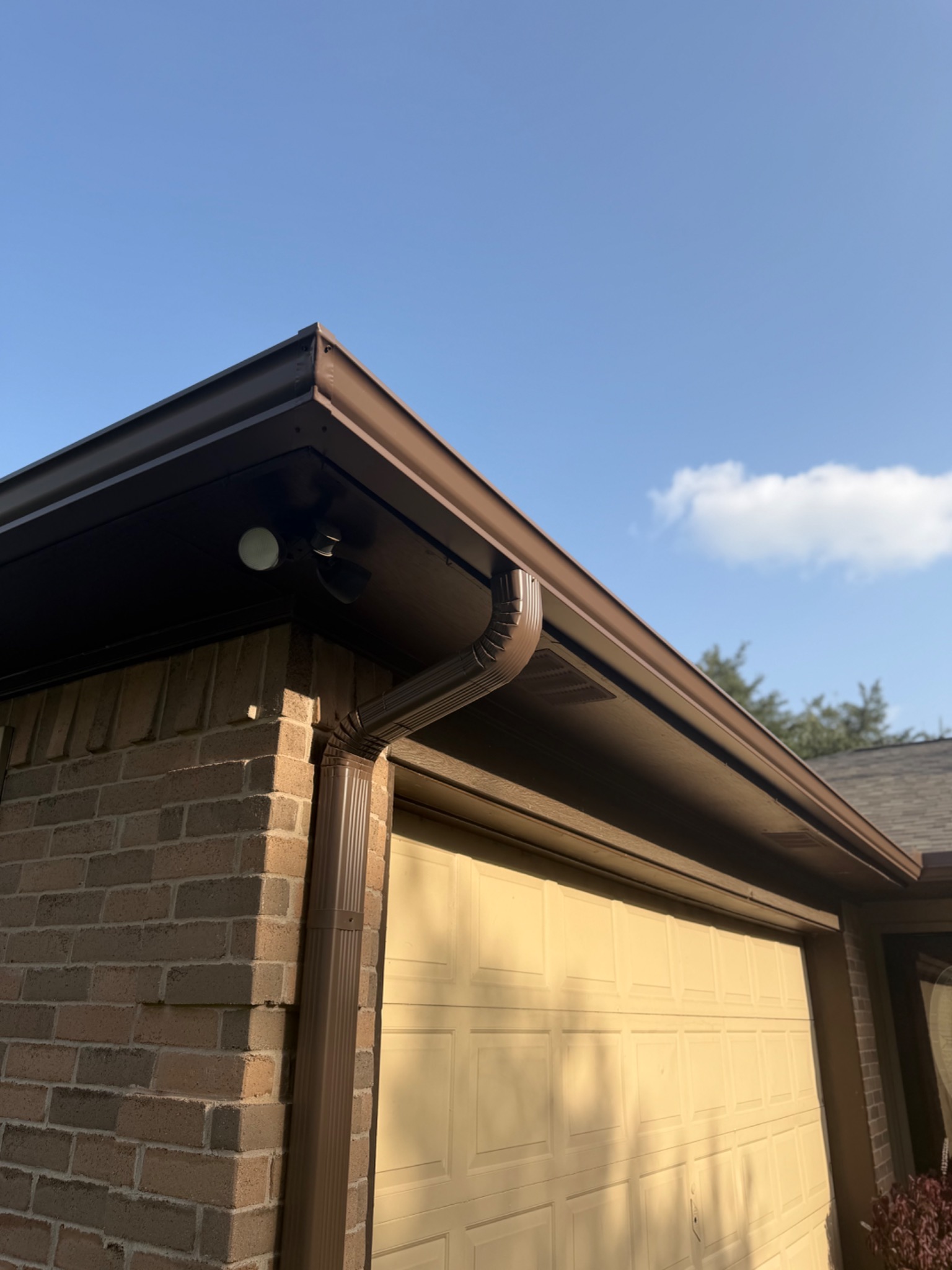 Seamless gutter and downspout installation